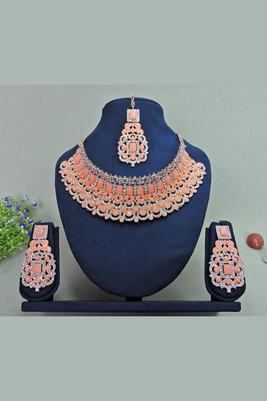 Beguiling Peach Color Alloy Necklace With Earrings and Mang Tikka