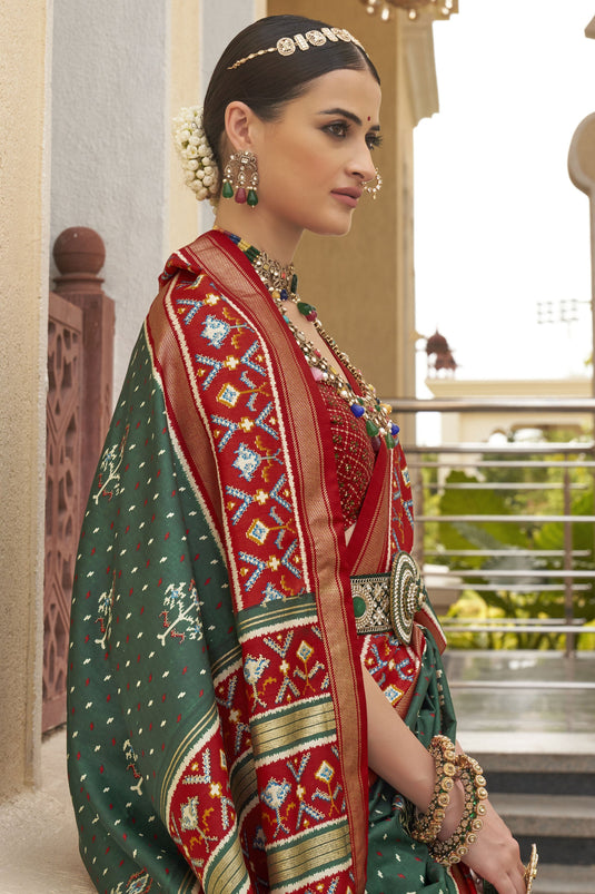 Attractive Dark Green Printed Patola Silk Traditional Saree