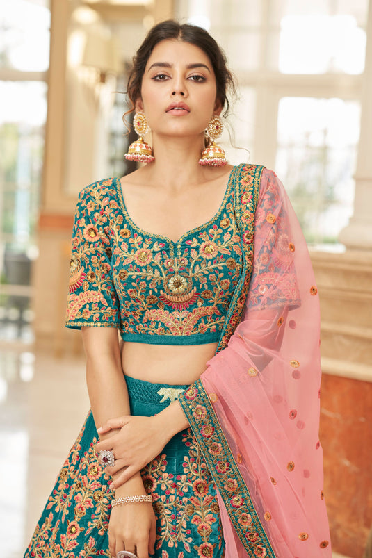 Ingenious Embroidered Teal Color Velvet Fabric Wedding Wear Lehenga