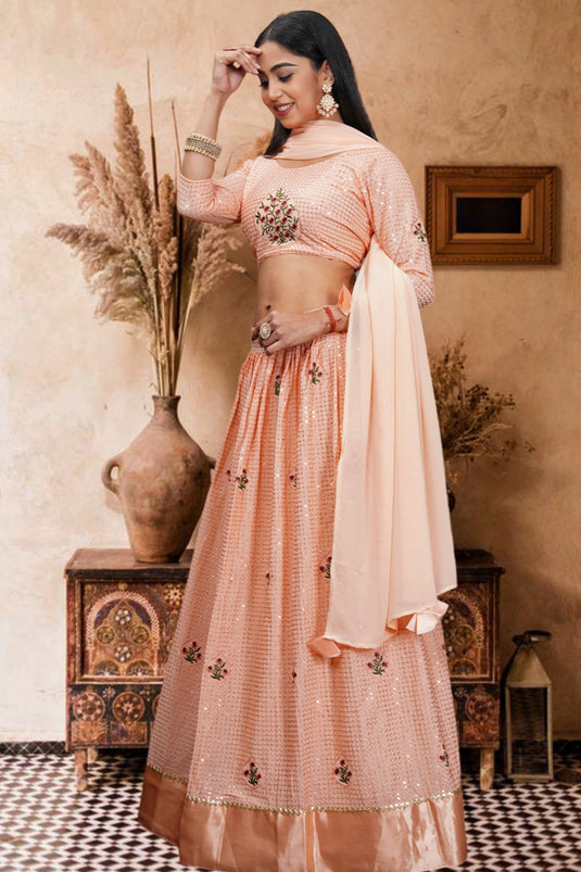 Trendy Net Fabric Peach Color Lehenga With Sequins Work