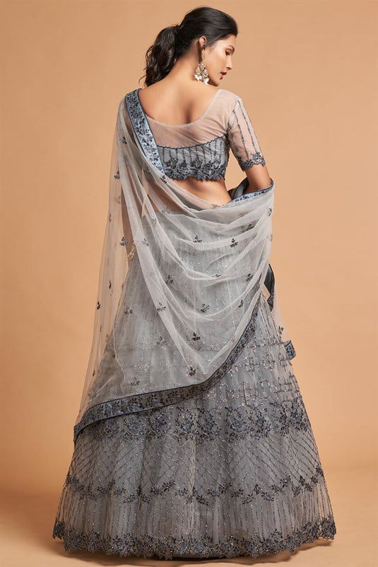 Grey Color Net Fabric Sangeet Wear Precious Lehenga With Embroidered Work