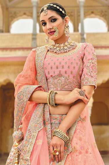 Embroidered Work Silk Fabric Peach Color Enticing Bridal Lehenga